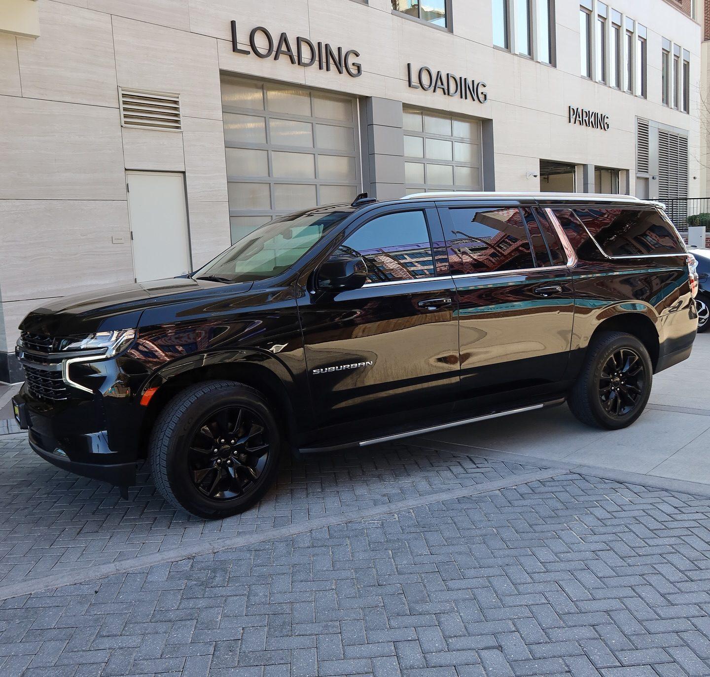 Black Chevrolet Suburban executive SUV on a city street