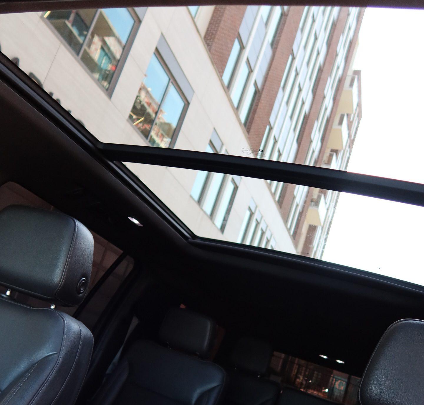 Panoramic glass roof over black leather rear seats