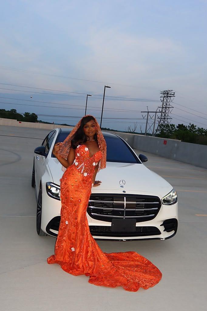 A guest beside a white Mercedes-Benz S-Class before a special event at dusk